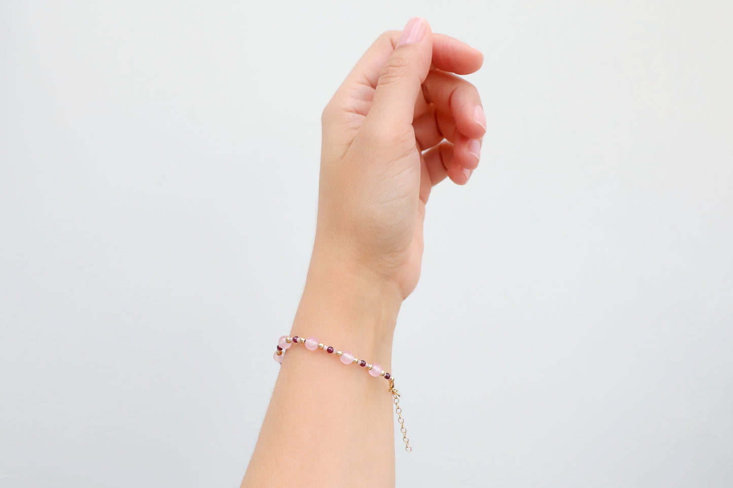 Bracelet made with 6mm Rose Quartz, 3mm Garnet and tiny 2mm Rhodochrosite beads, and Gold Filled details.