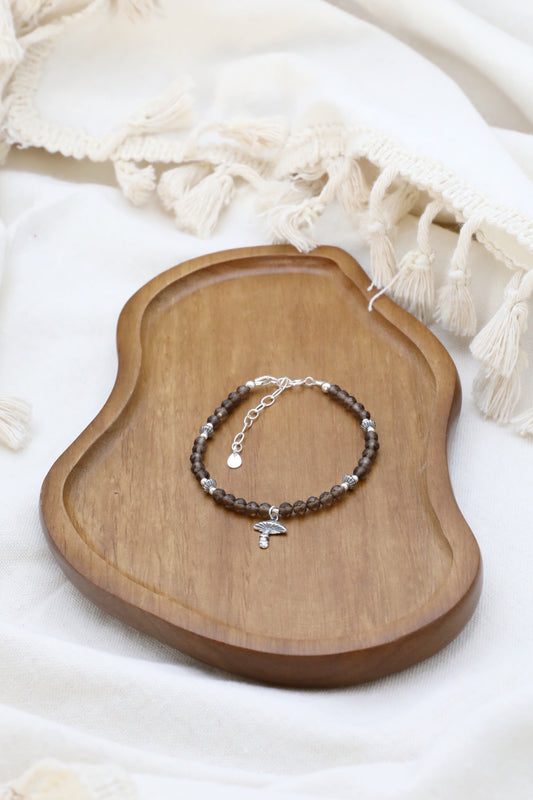 The Steadfast Spirit Bracelet by Gaia's Heirlooms, made with faceted Smoky Quarts beads and oxidised Sterling Silver details.