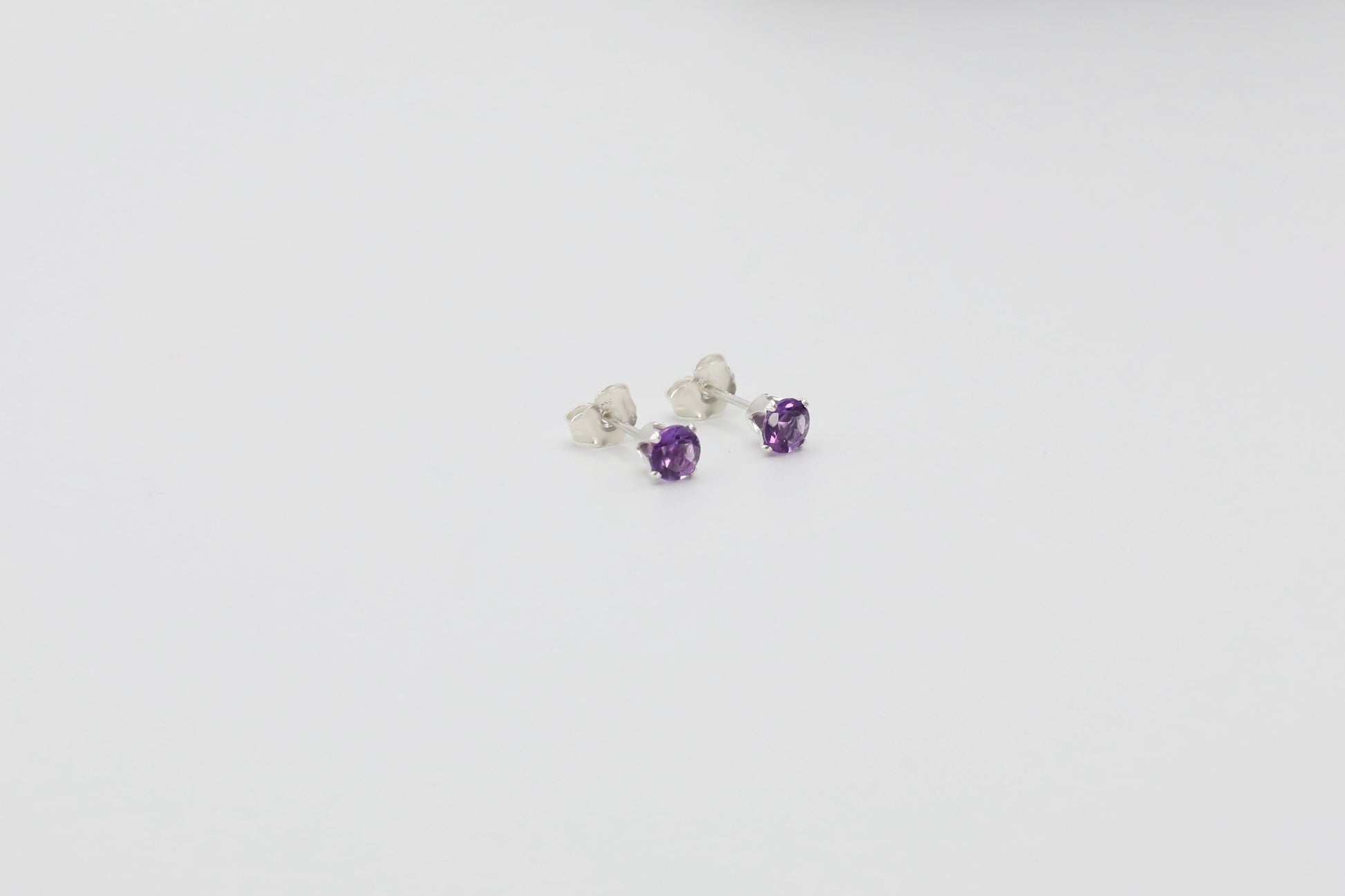 Pair of Amethyst stud earrings in Sterling Silver.
Size: 4mm