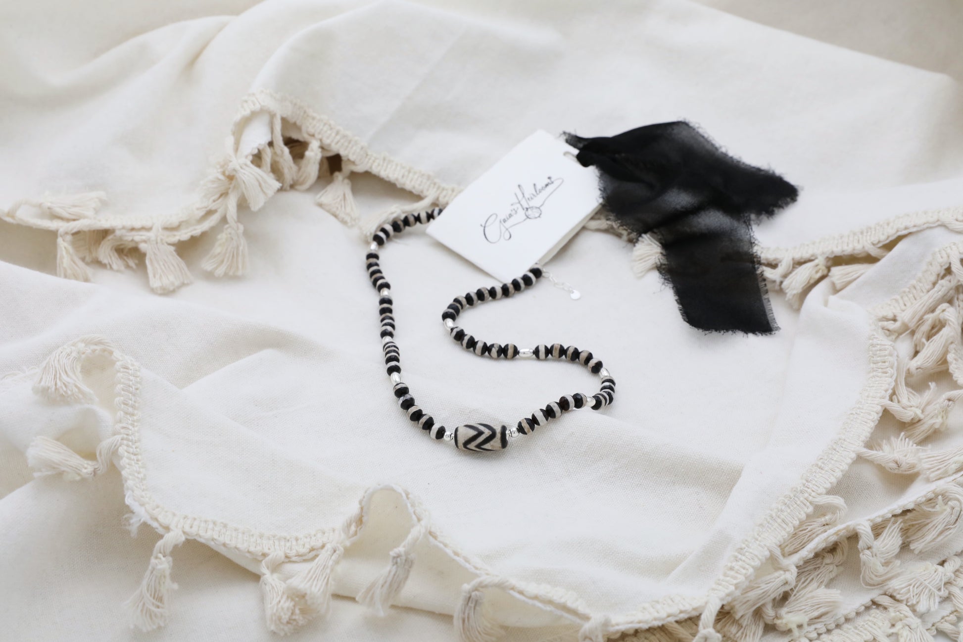 The Ancient Wisdom Necklace by Gaia's Heirlooms, made with black and white Tibetan Agates and Sterling Silver.