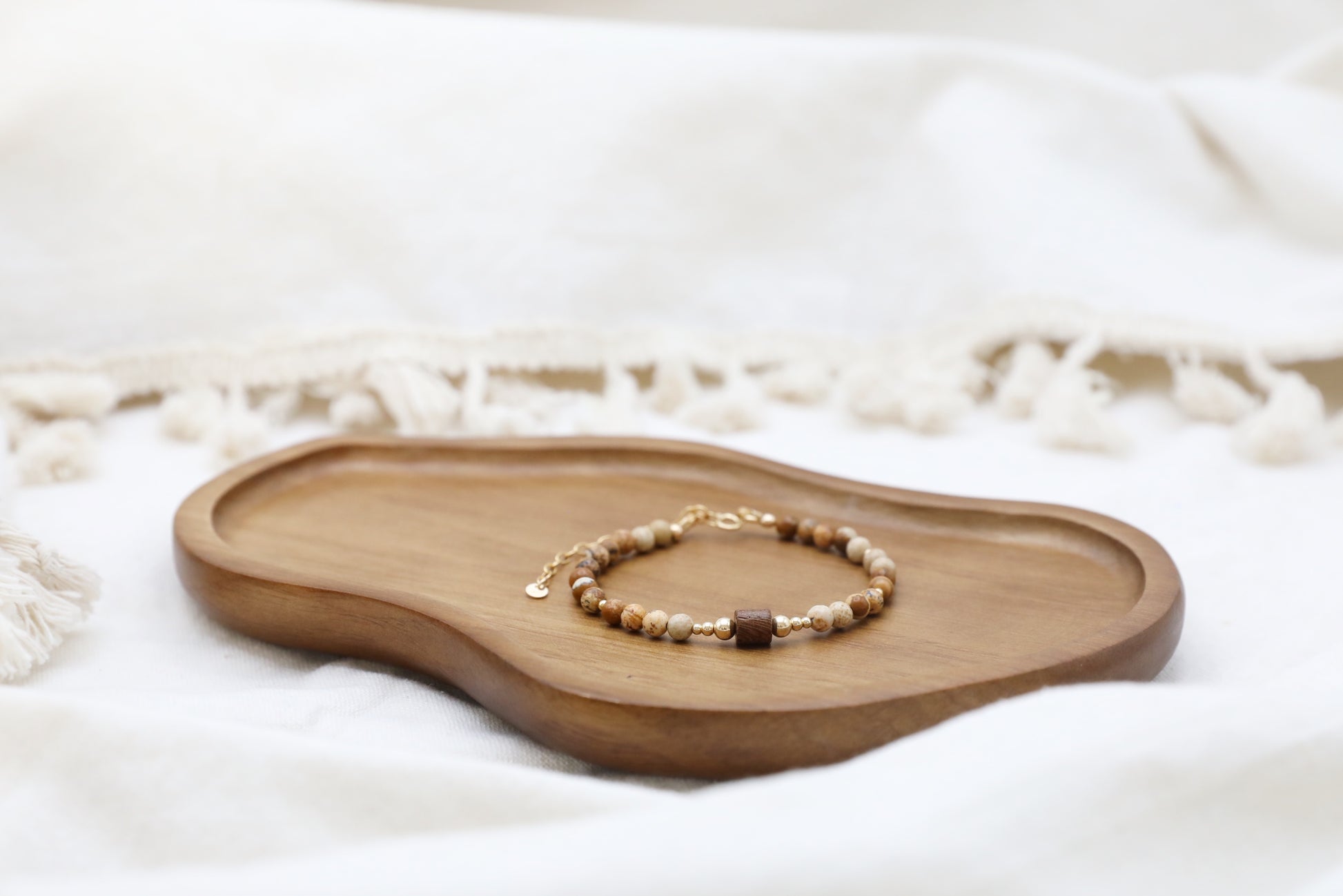 The Earth's Story Bracelet by Gaia's Heirlooms, made with Picture Jasper beads, a natural wood bead in the middle and Gold Filled details.