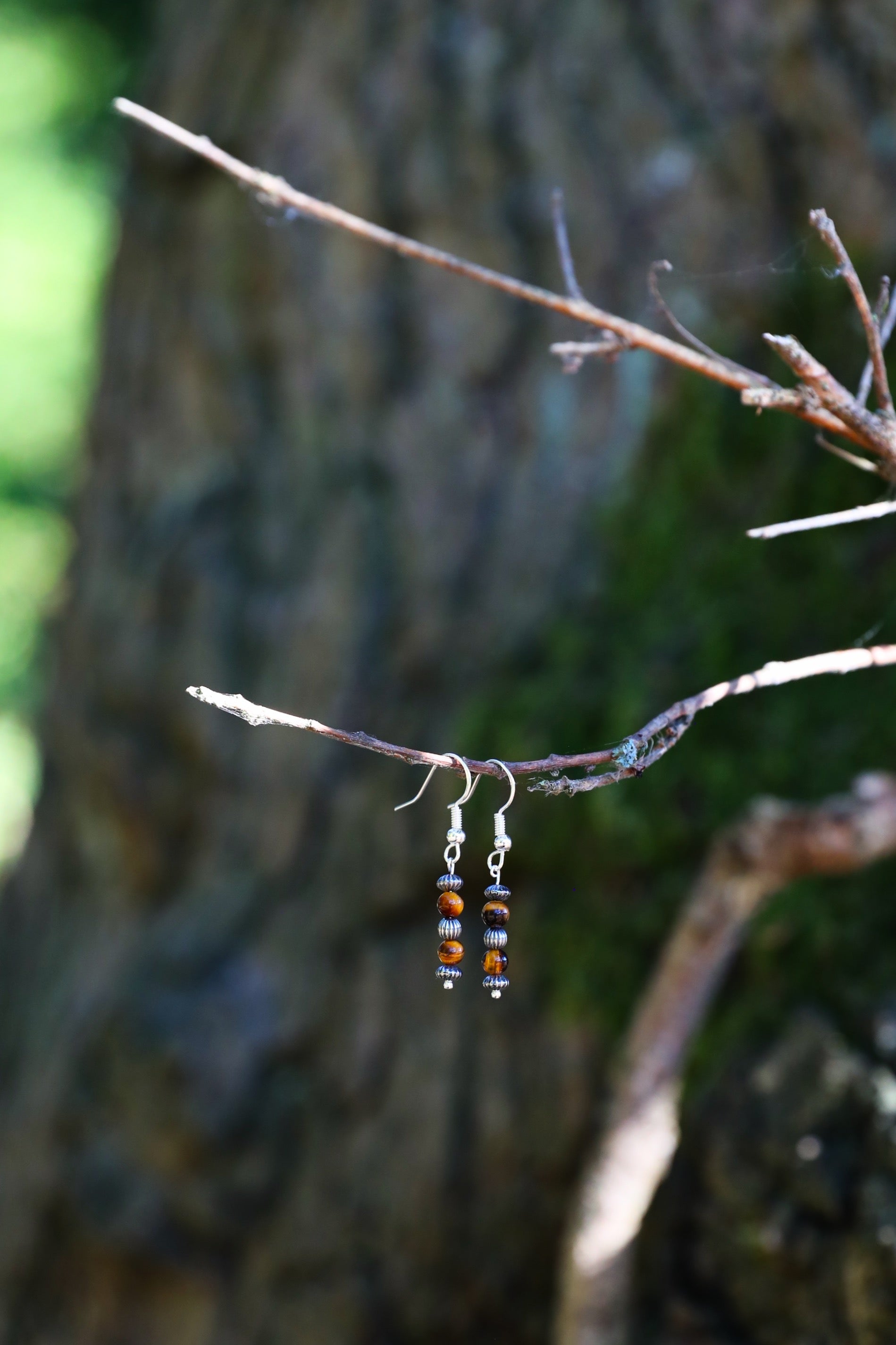 The Fierce Wisdom Earrings from Gaia's Heirlooms, made with Tiger's Eye and oxidised Sterling Silver beads.