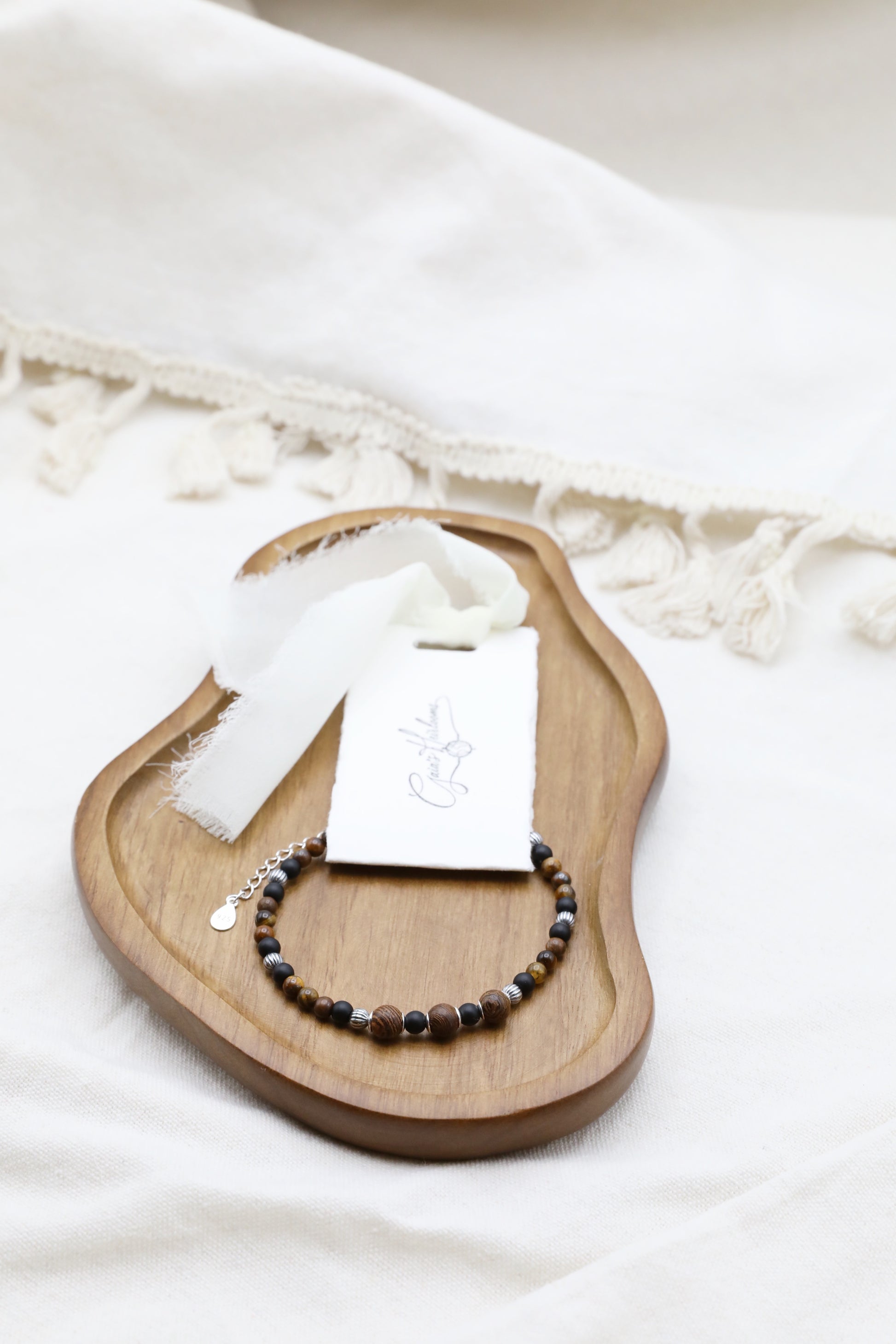 The Fierce Wisdom Bracelet by Gaia's Heirlooms, made with Tiger's Eye, matte Black Onyx, natural wood and oxidised Sterling Silver beads.