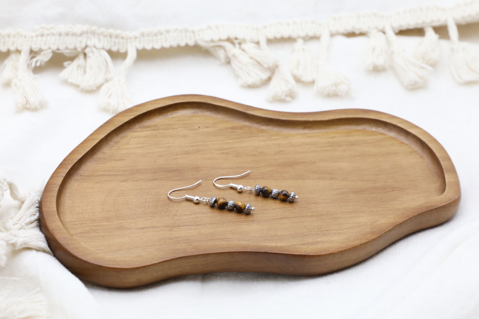 The Fierce Wisdom Earrings from Gaia's Heirlooms, made with Tiger's Eye and oxidised Sterling Silver beads.