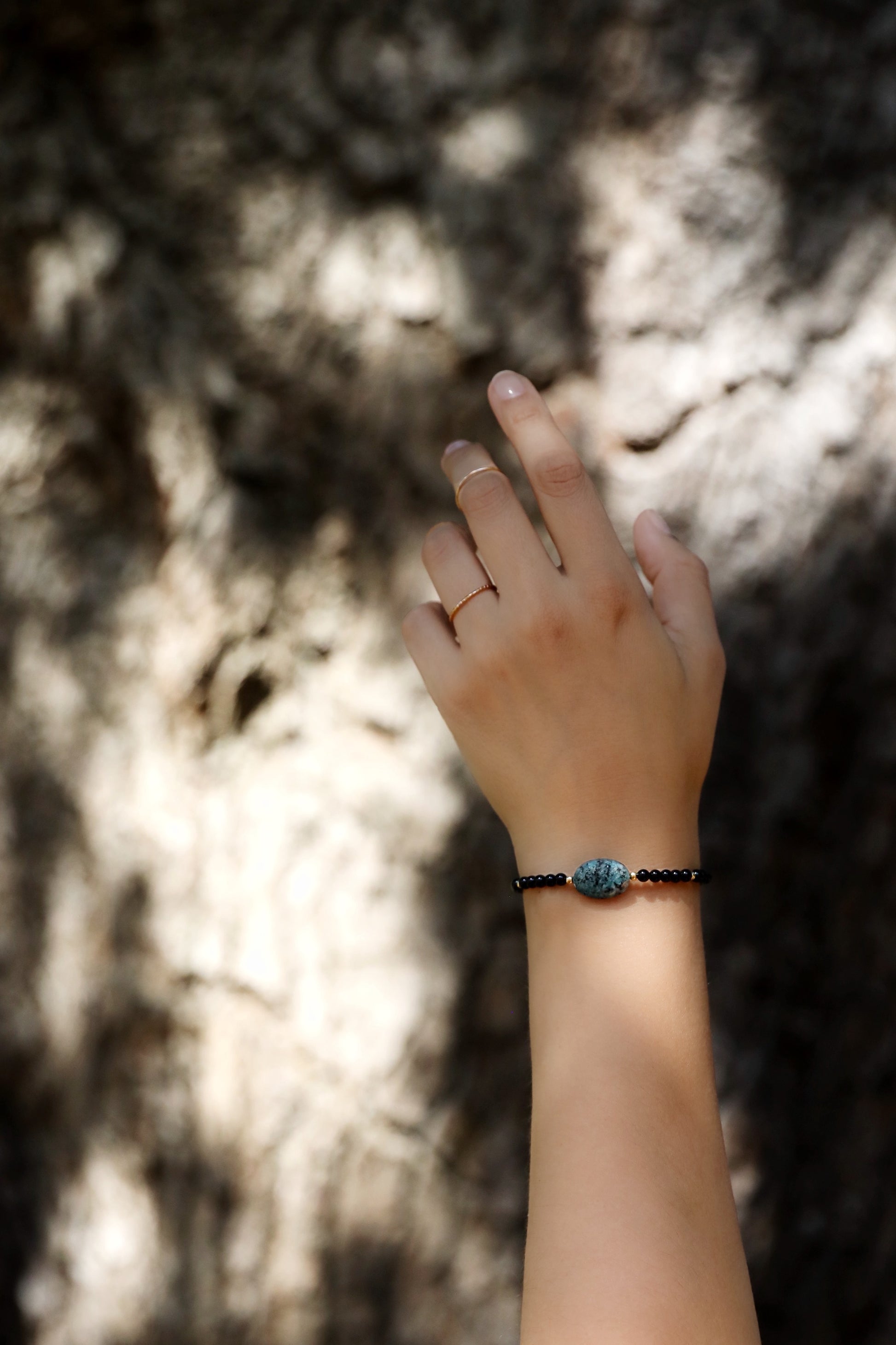 The Fortifying Foundations Bracelet by Gaiai's Heirlooms, made with Black Onyx beads, three Blue Spot Jasper stones in the middle and Gold Filled details.