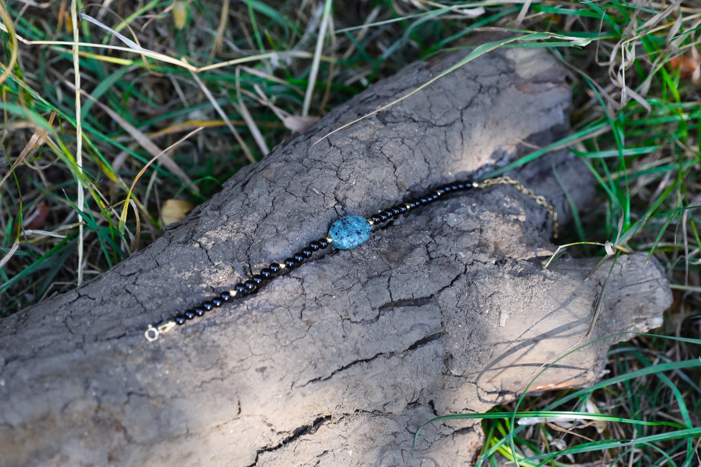 The Fortifying Foundations Bracelet by Gaiai's Heirlooms, made with Black Onyx beads, three Blue Spot Jasper stones in the middle and Gold Filled details.
