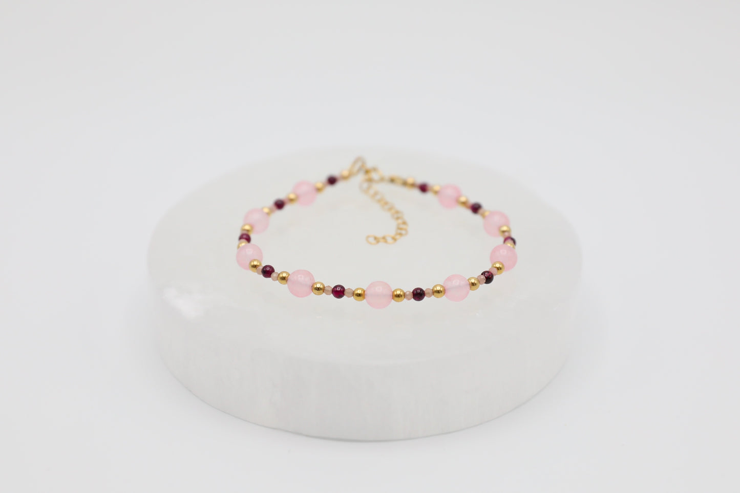 Bracelet made with 6mm Rose Quartz, 3mm Garnet and tiny 2mm Rhodochrosite beads, and Gold Filled details.