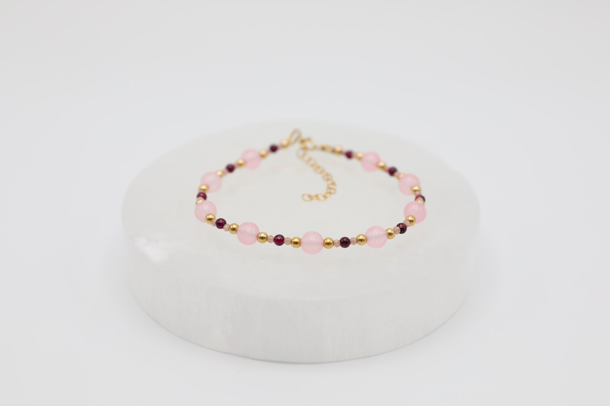 Bracelet made with 6mm Rose Quartz, 3mm Garnet and tiny 2mm Rhodochrosite beads, and Gold Filled details.