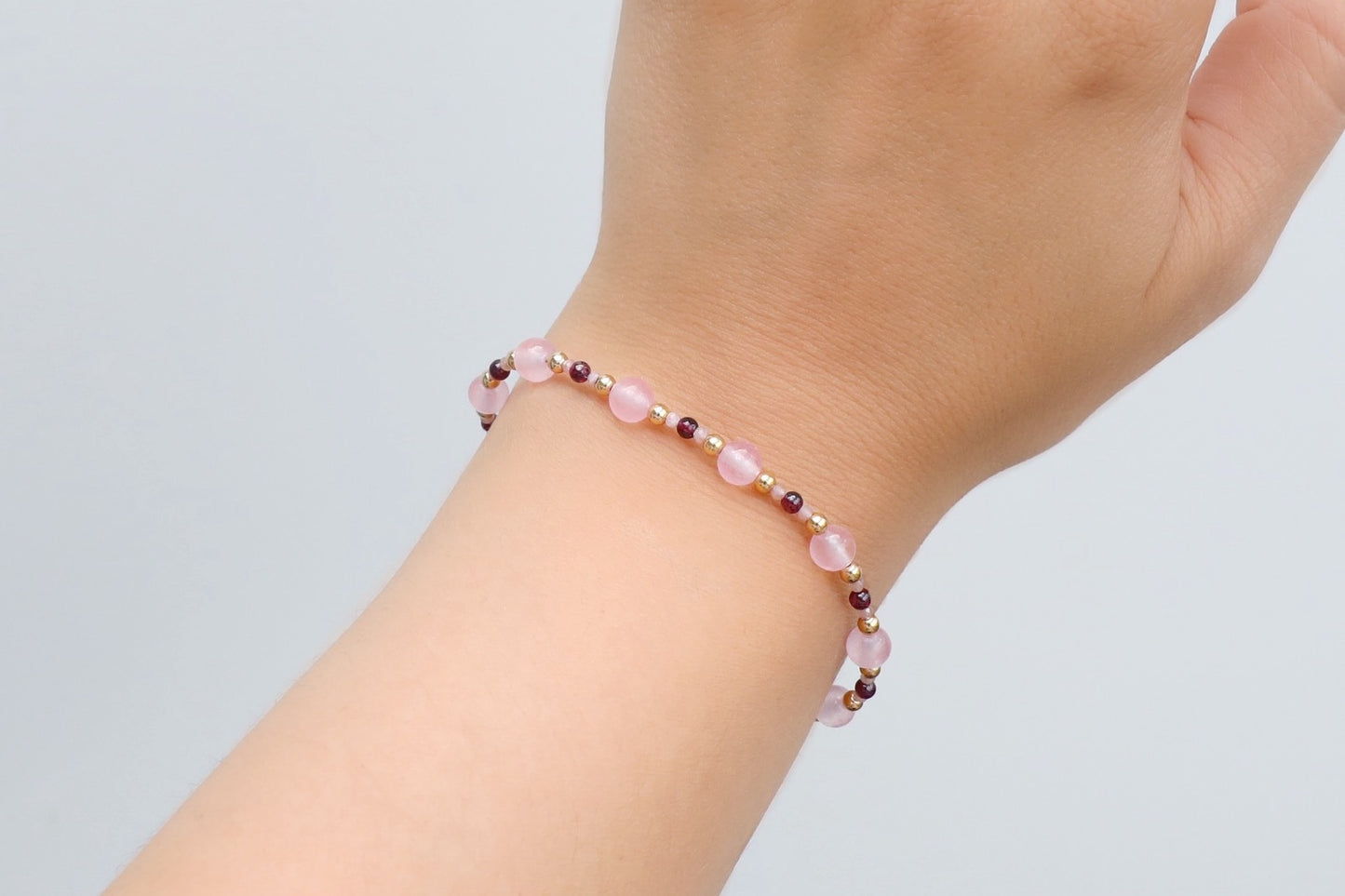 Bracelet made with 6mm Rose Quartz, 3mm Garnet and tiny 2mm Rhodochrosite beads, and Gold Filled details.