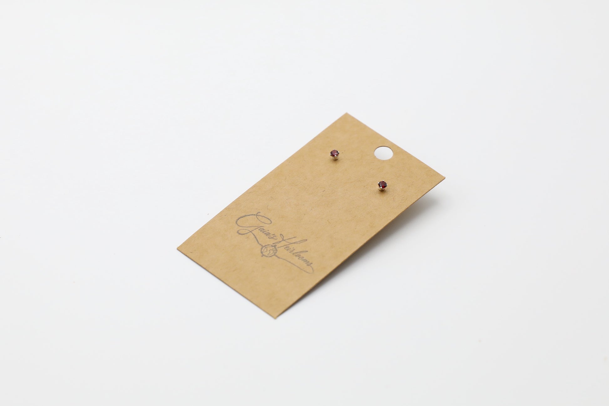 Pair of dainty Garnet stud earrings in Sterling Silver. Size: 3mm