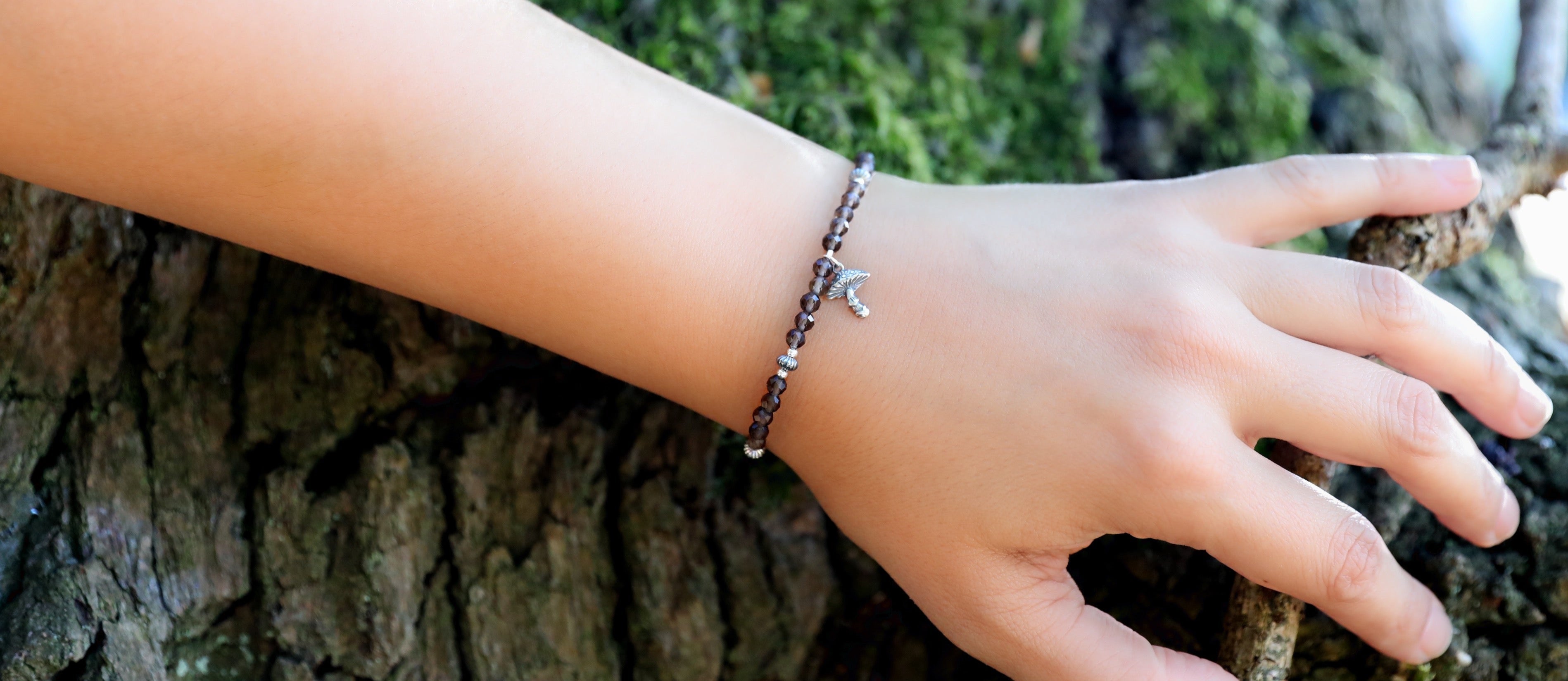 The Steadfast Spirit Bracelet by Gaia's Heirlooms, made with faceted Smoky Quarts beads and oxidised Sterling Silver details.