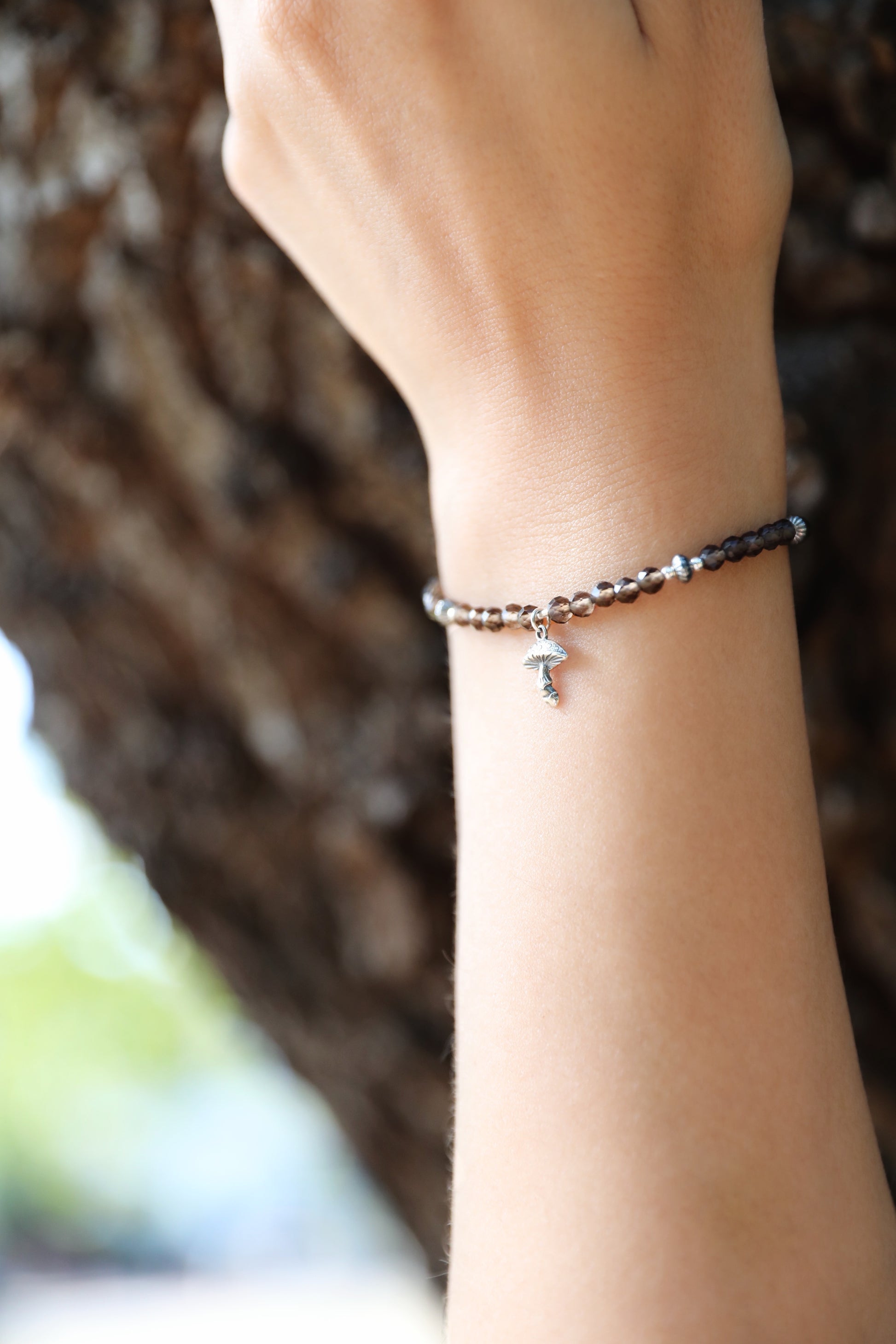 The Steadfast Spirit Bracelet by Gaia's Heirlooms, made with faceted Smoky Quarts beads and oxidised Sterling Silver details.