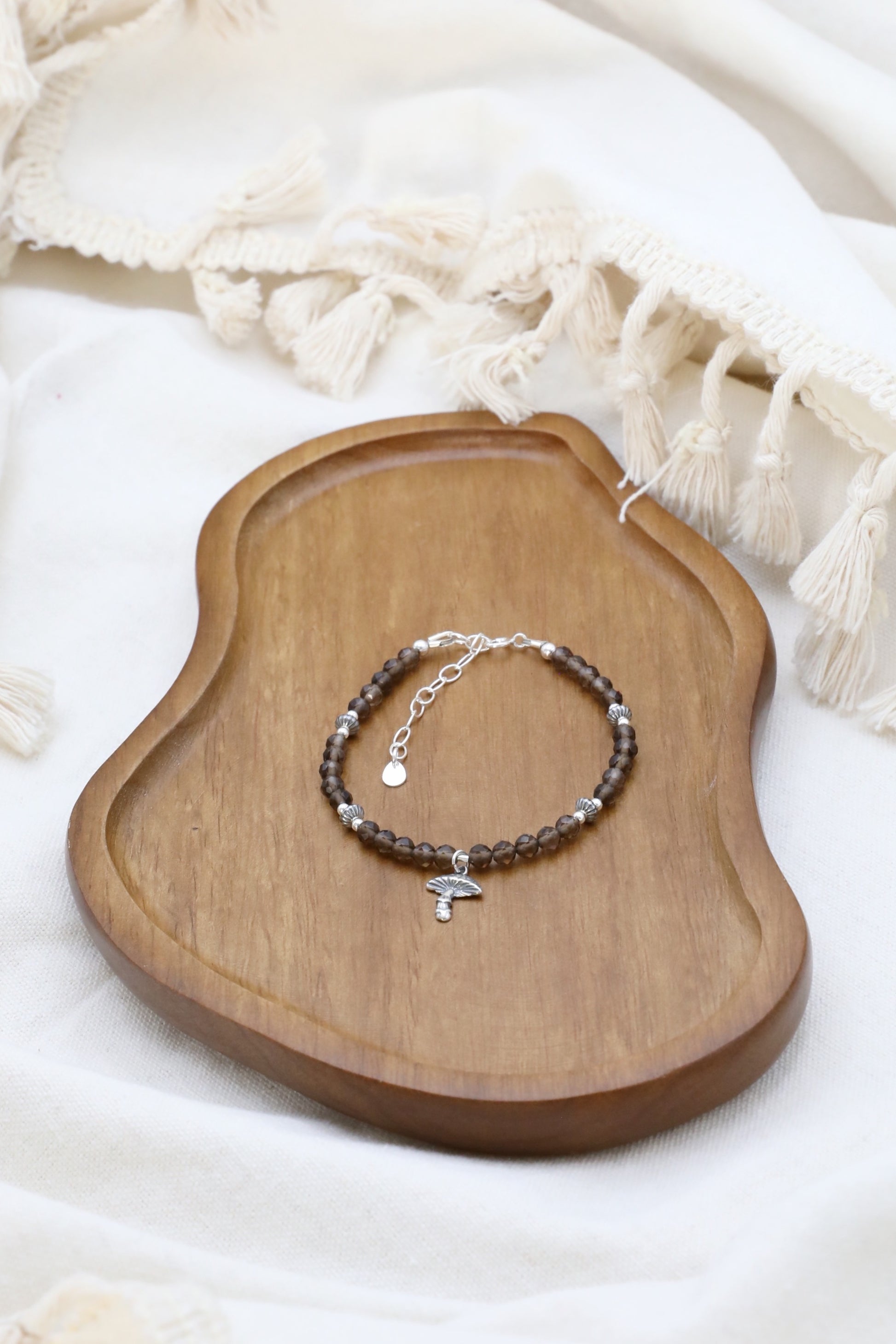 The Steadfast Spirit Bracelet by Gaia's Heirlooms, made with faceted Smoky Quarts beads and oxidised Sterling Silver details.