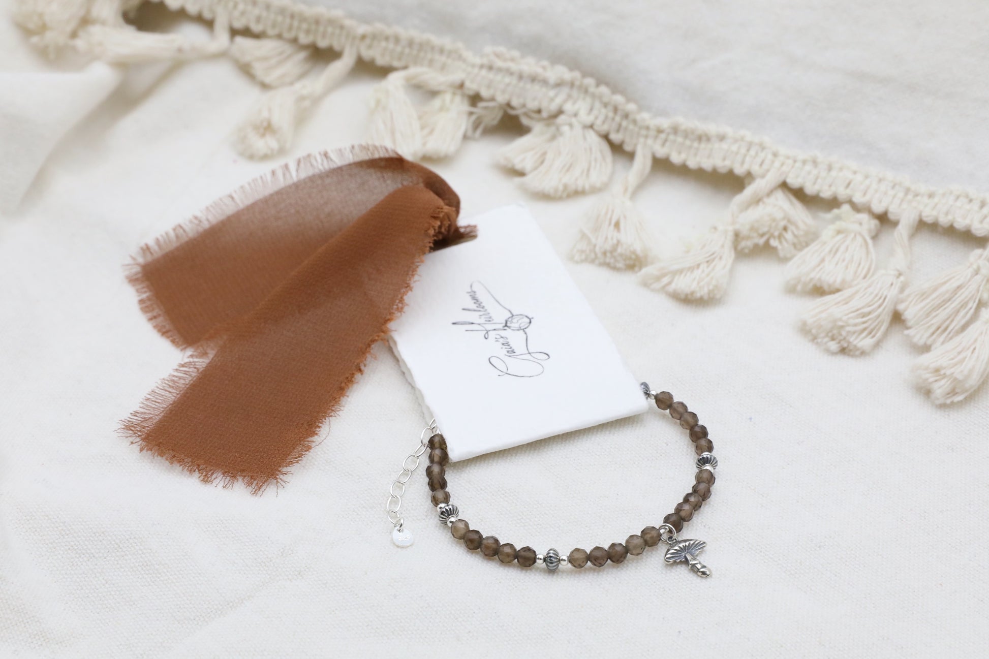 The Steadfast Spirit Bracelet by Gaia's Heirlooms, made with faceted Smoky Quarts beads and oxidised Sterling Silver details.