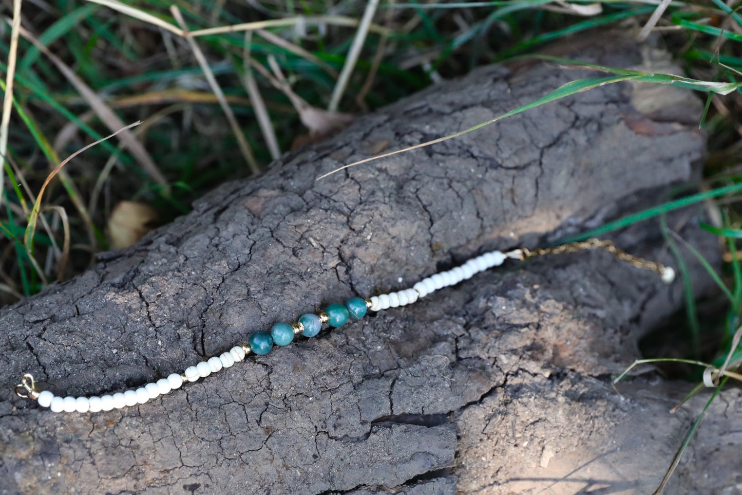 The Stillness Bracelet by Gaia's Heirlooms, made with Howlite and Moss Agate beads, finished with Gold Filled details.