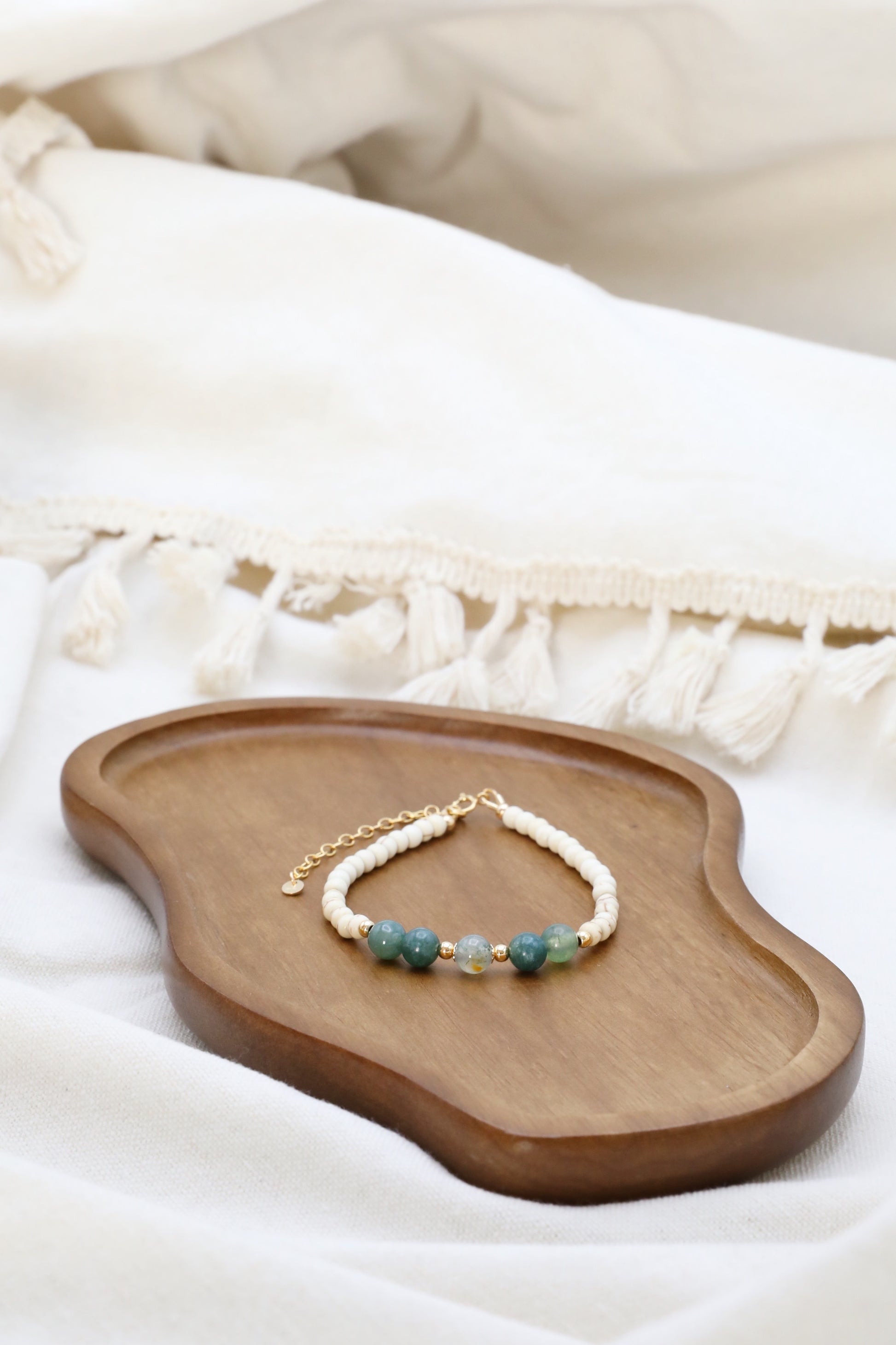 The Stillness Bracelet by Gaia's Heirlooms, made with Howlite and Moss Agate beads, finished with Gold Filled details.
